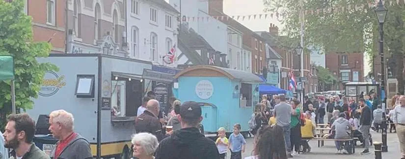 photo shows Stone Sunday Series taking place on the high street of Stone. There are traders and people in the photo.