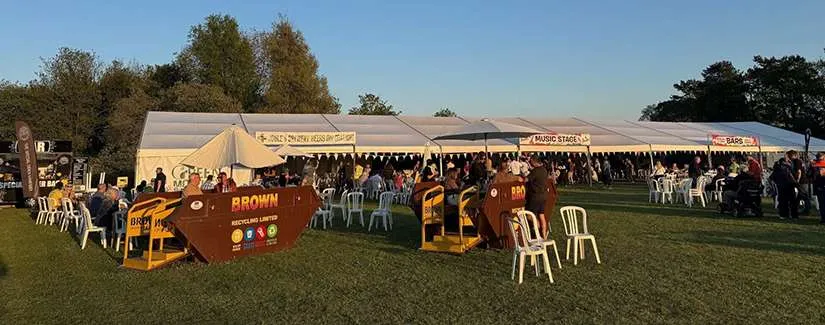 Stone Food and Drink Festival crowd at Westbridge Park supported by Brown Recycling who have converted skips into picnic tables for the show